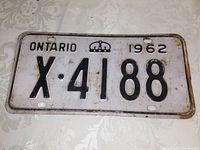 Front view of the 1962 Ontario license plate showing embossed black alphanumeric code X-4188 on white background with the crown symbol.