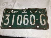 Front photo of vintage 1964 Ontario license plate showing embossed characters 31060-G and date SEP 64