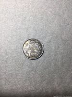 Reverse side showing denomination, year, and wreath design