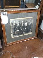 Full view of the framed antique black and white family portrait showing the frame's condition.