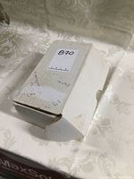 Closed white cardboard box with handwritten note and label, identified as containing hockey cards.