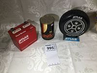 One photo showing three vintage promotional radios with garage themes: ATLAS Red Brute rectangular radio, Uniflo oil can replica, and ATLAS tire-shaped radio on blue stand