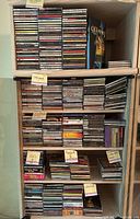 Shelf with numerous CDs sorted by genre: jazz, gospel, reggae, 50s, soul, and world music, boxed set visible.