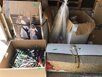 Boxes containing Christmas nativity set and exterior decorations including lights and figures.