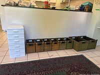 Overall shot of the two white plastic drawer units and the eight wooden organizer bins placed in a row underneath a counter.