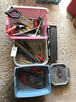 Overview of tools including saws, clamps, ratchet socket set, files, and miscellaneous hand tools in plastic tubs and a metal box.