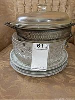 Stack showing Roseville Translucent #4135 china plates with floral designs and the heavy crystal cut glass bowl underneath.