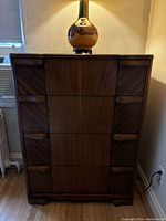 Front view of Art Deco highboy showing four walnut veneer drawers