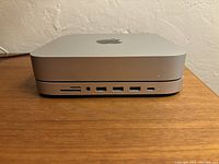 Front view showing stacked Mac mini on top of Satechi aluminum hub and stand with visible ports including SD card slot, headphone jack, USB ports, and Type-C port.