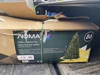 Box showing NOMA Collins Lighted Tree branding with some damage to box corners