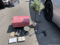 Full view of all lot items including pink foot stool, artificial tree, mirror, soaps, lamp and glue tool with wax sticks.