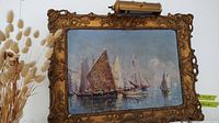 Ornate carved gilt frame with watercolor of sailing ships on water