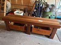 Wooden bench with two wooden storage boxes underneath, showing front, side, and top views in a garage setting.