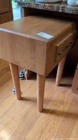 Side view showing table profile, legs and drawer