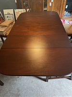 Table fully open, overhead view showing dark wood top and center seams