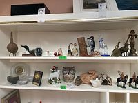 Two shelves view showing full assortment of decorative figurines and decor items