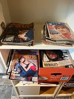 Top shelf two stacks showing Rave magazine covers including Monkees Special and actor cover