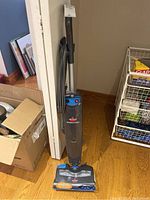 Front and side view photo of the upright Bissell Steam & Sweep vacuum cleaner model 4684-C showing the full upright machine with handle, power cord, and cleaning head.