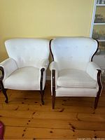 Both chairs side by side showing frames, upholstery, tufted backs and slight differences