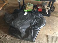 Black Shur Trax all weather traction mat folded on the ground.