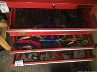 Drawer with assorted screwdrivers, box cutters, and small hand tools