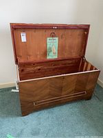 Open cedar chest showing the interior and lower drawer with the herringbone front pattern