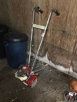 Full view of tiller leaning against wooden wall