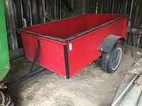 Side view of red painted wood box and black frame