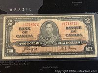 Full front view of the 1937 Canadian two dollar banknote highlighting the portrait of King George VI, serial number, and bilingual text.
