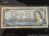 Front side of the 1954 Canadian five dollar banknote showing the Queen Elizabeth II portrait, serial number, and Bank of Canada text.