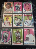 Front view of nine 1970-71 O-Pee-Chee NHL hockey cards showing players from various teams with colorful backgrounds, displayed in plastic sleeve.
