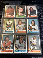 Front of 9 1974-75 O-Pee-Chee NHL hockey cards showing player images and team logos