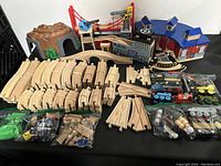 Full lot overview showing wooden tracks, mountain tunnel, cranes, station buildings, and trains still in bags.