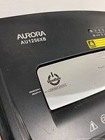Close-up of the top part showing the Aurora AU1250XB branding and the shredder status indicator with shred safe graphics.