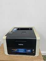 Front and top view of Brother HL-3170CDW laser printer showing model branding and printer body.