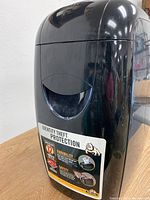 Close-up of the front of the Fellowes paper shredder showing identity theft protection label and features.