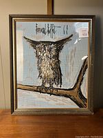 Front view of framed tapestry depicting owl on branch