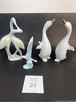 Five Hollohaza porcelain bird figurines shown from front on black background.