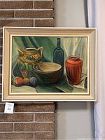 Full view of the framed still life painting hung on wall showing overall composition and colors.