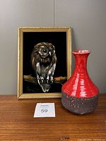 Full view of the lot showing the red and dark brown Fat Lava vase next to the framed owl painting on black velvet.