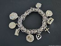 Top view of bracelet with charms visible on black background