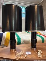 Front view of both lamps with shades installed on wood table, showing overall height and style