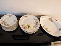 7-8 piece china dish set including plates and an oval serving tray all showing a matching floral pattern and scalloped edges