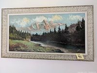 Oil painting landscape with mountains, trees, river, and white decorative carved frame