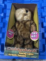 Front view of the Caddyshack Dancing Gopher toy in original box showing the fluffy brown gopher and 'Try Me' stickers.