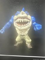 Front view of the 1994 Street Sharks Ripster figure showing blue arms, muscular torso, open shark mouth with sharp teeth, beige pants, and brown boots.