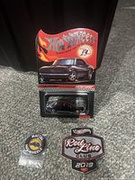 Photo of Hot Wheels Custom Camaro in original blister card package with Red Line Club logo above car image and flame design background