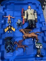 Blue tray with 8 assorted vintage action figures including humanoid and creature figures