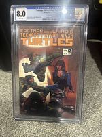 Front cover of Teenage Mutant Ninja Turtles #2 comic book in CGC protective case graded 8.0.