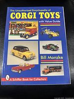 Front cover of the encyclopedia showing the title, author, and various Corgi Toys models in full color.